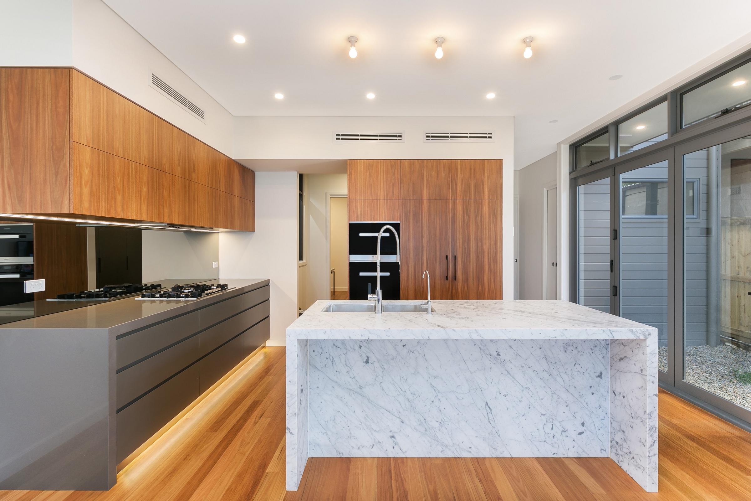 Annandale, Timber Veneer and polyurethane kitchen with a Carrara Marble feature island