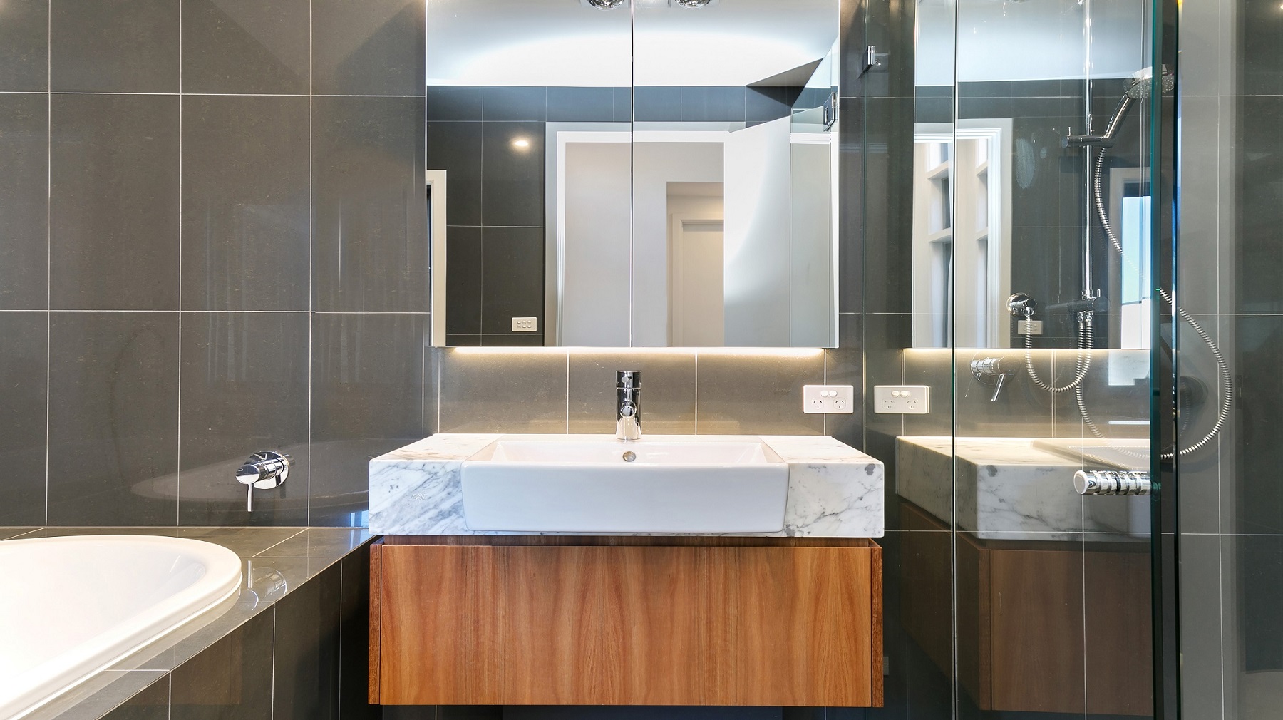 Timber Veneer vanity with a Carrara Marble top and mirror cabinets above - Annandale, Sydney