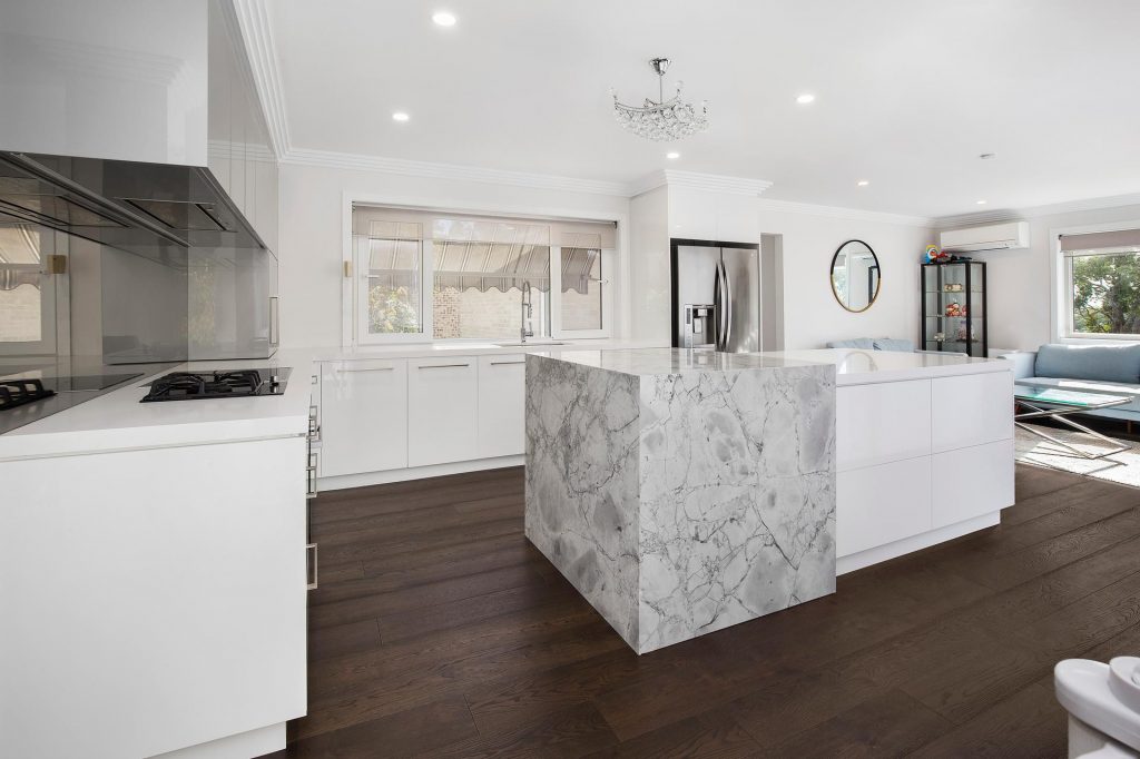 Bangor - Ultraglaze kitchen in Superior White and Premiere Metallic featuring a stone island cube