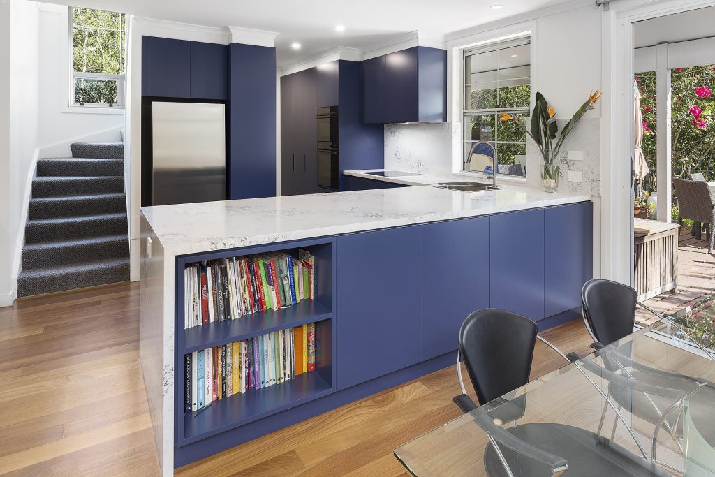 AFTER Rozelle Renovation, Polyurethane Kitchen with a 40mm stone benchtop and splashback, featuring a pocket shelf in the breakfast bar