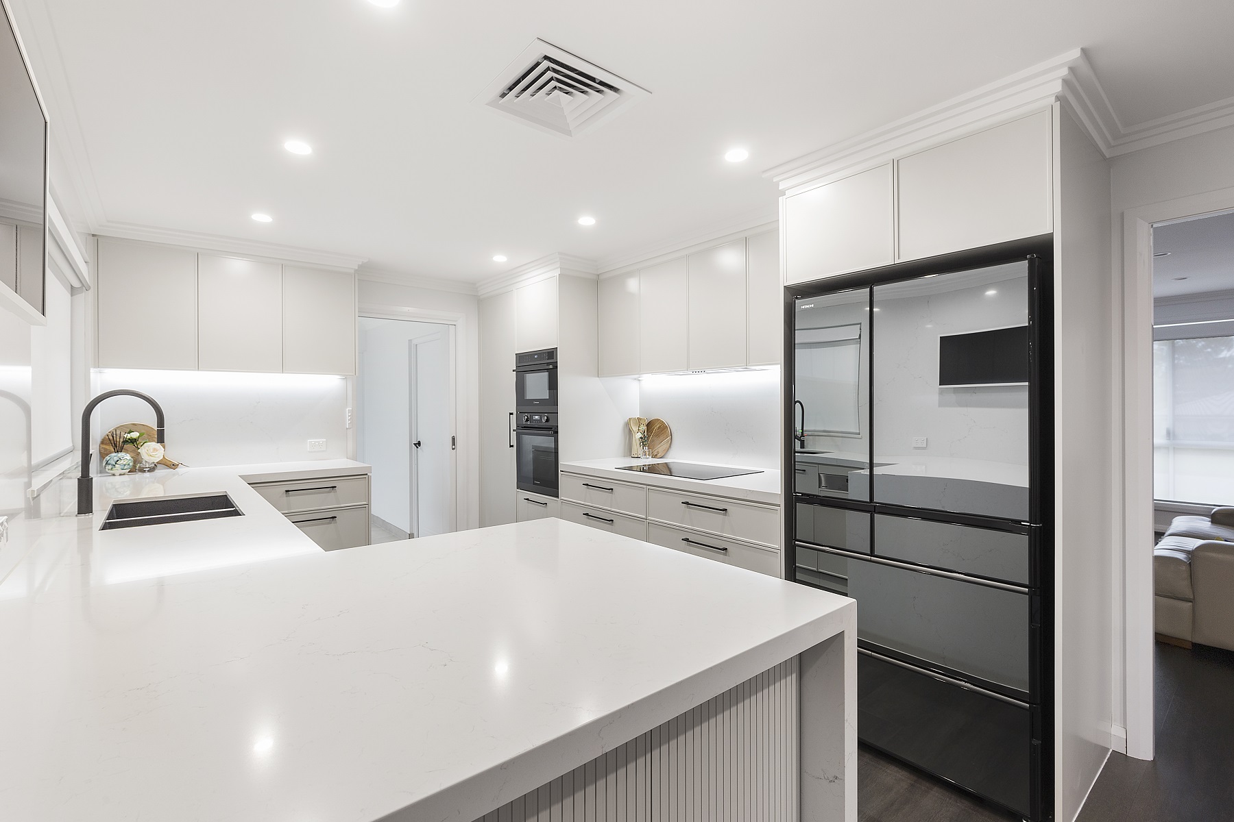AFTER Moorebank Renovation, Polyurethane Thin Shaker kitchen with a stone benchtop and featuring a fluted paneled breakfast bar