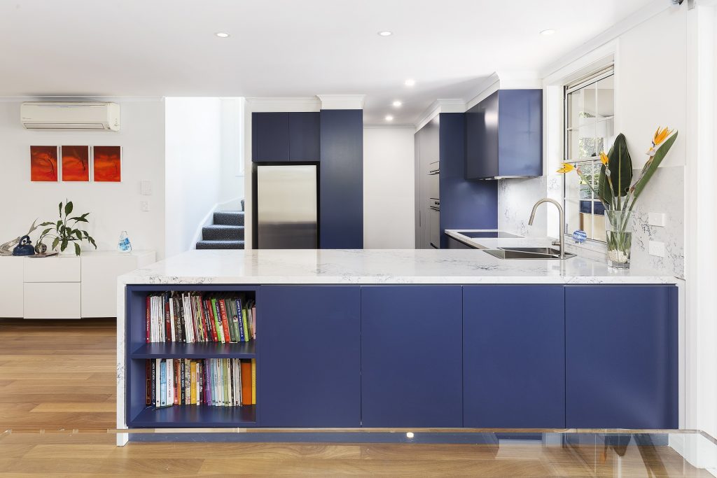 AFTER Rozelle Renovation, Polyurethane Kitchen with a 40mm stone benchtop and splashback, featuring a pocket shelf in the breakfast bar