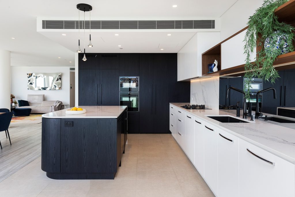 Milsons Point, Veneer Kitchen featuring a curved island bench with stone tops and splashback in Calcutta Plato