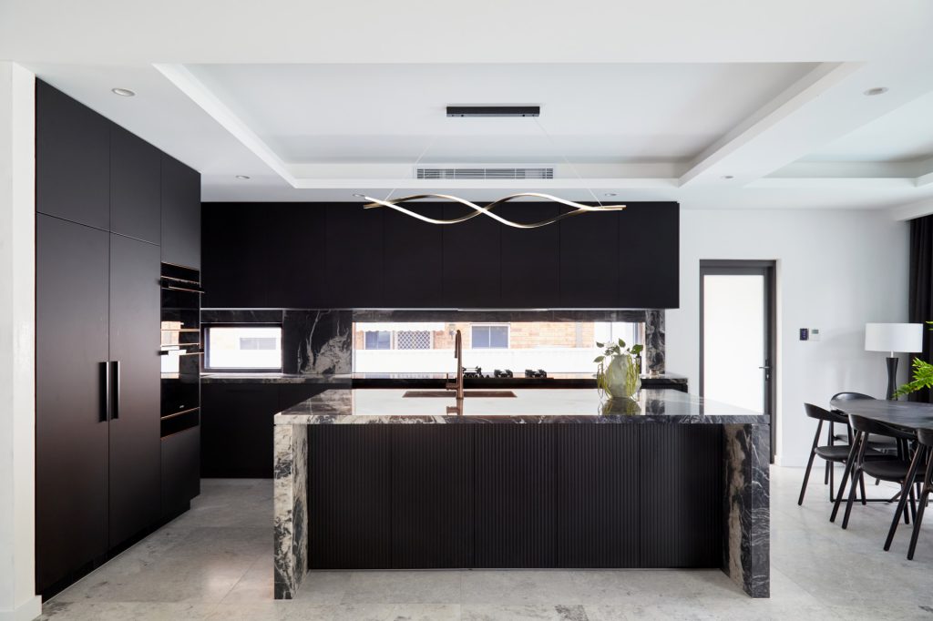 Strathfield, Fenix and Polyurethane Kitchen featuring an island bench with stone tops and splashback